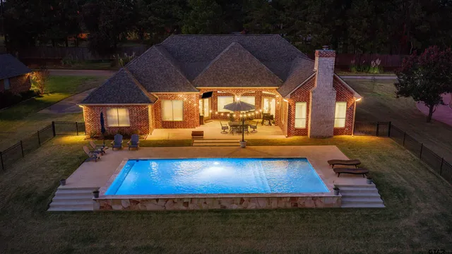 a view of a swimming pool with a patio