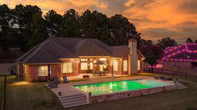 a front view of a house with a yard and potted plants