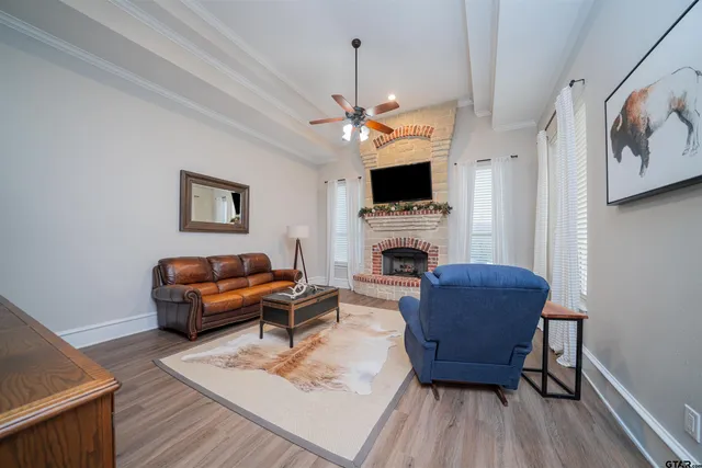 a living room with furniture a fireplace and a flat screen tv