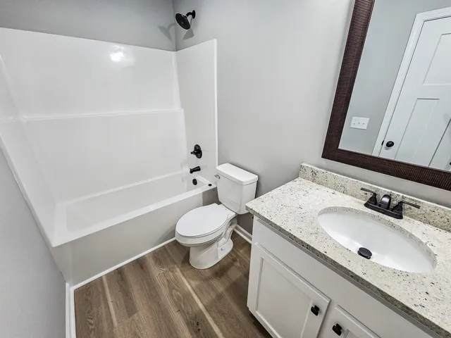 a bathroom with a sink a toilet and a bathtub