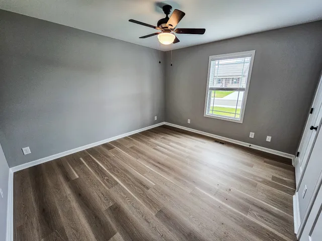 wooden floor in an empty room with a window