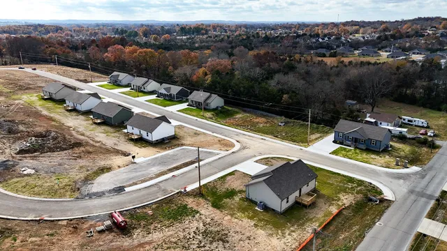 an aerial view of a house with a yard and large trees