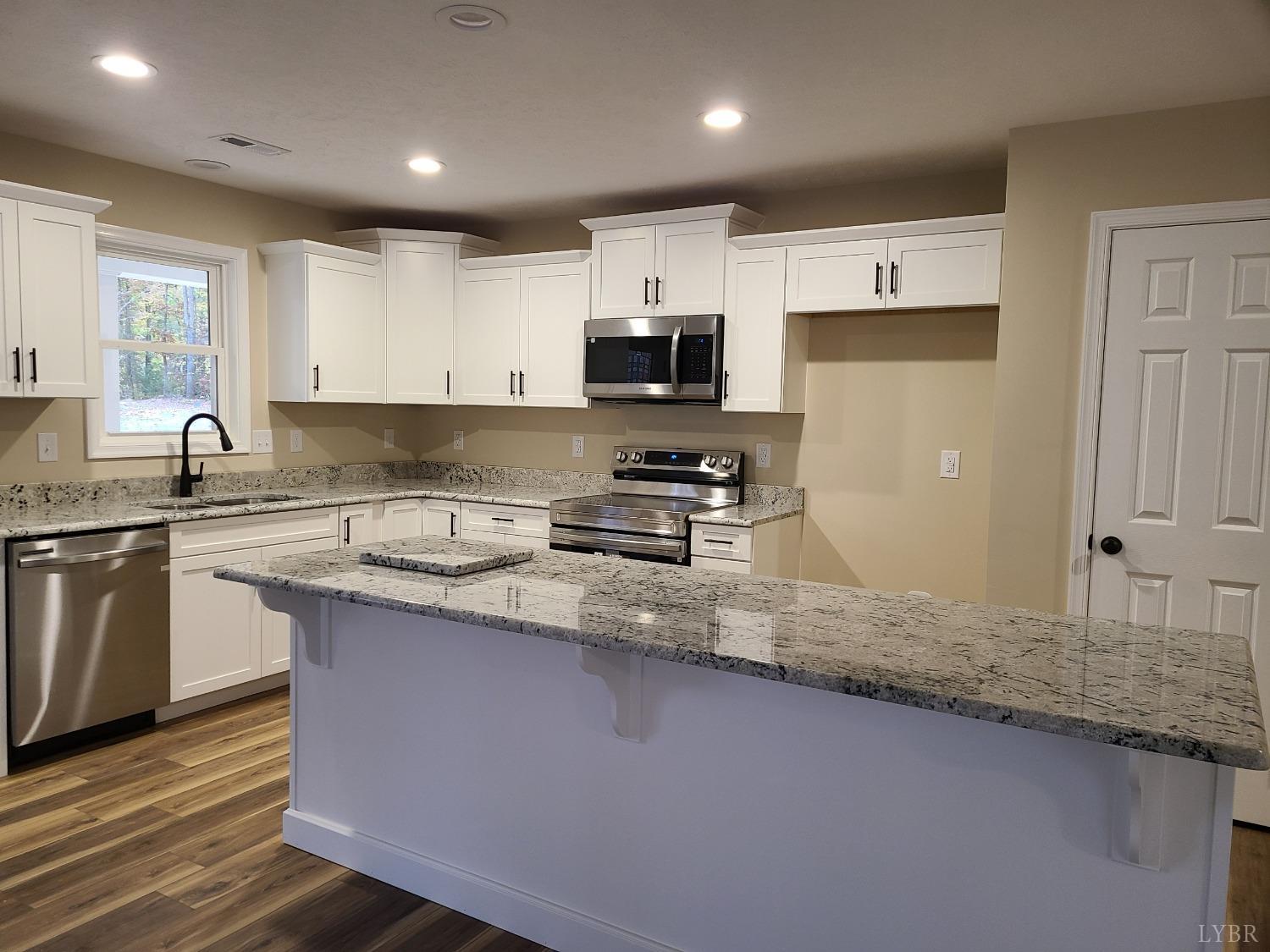 2375 Stonewall Road Concord, VA 24538 - Photo 2 of 13 a kitchen with stainless steel appliances granite countertop a sink stove and refrigerator