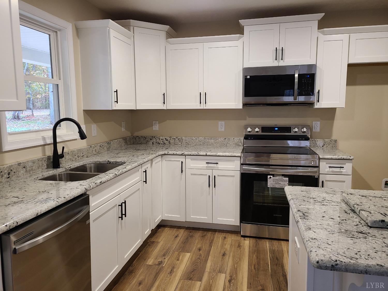 2375 Stonewall Road Concord, VA 24538 - Photo 3 of 13 a kitchen with a sink stove and cabinets