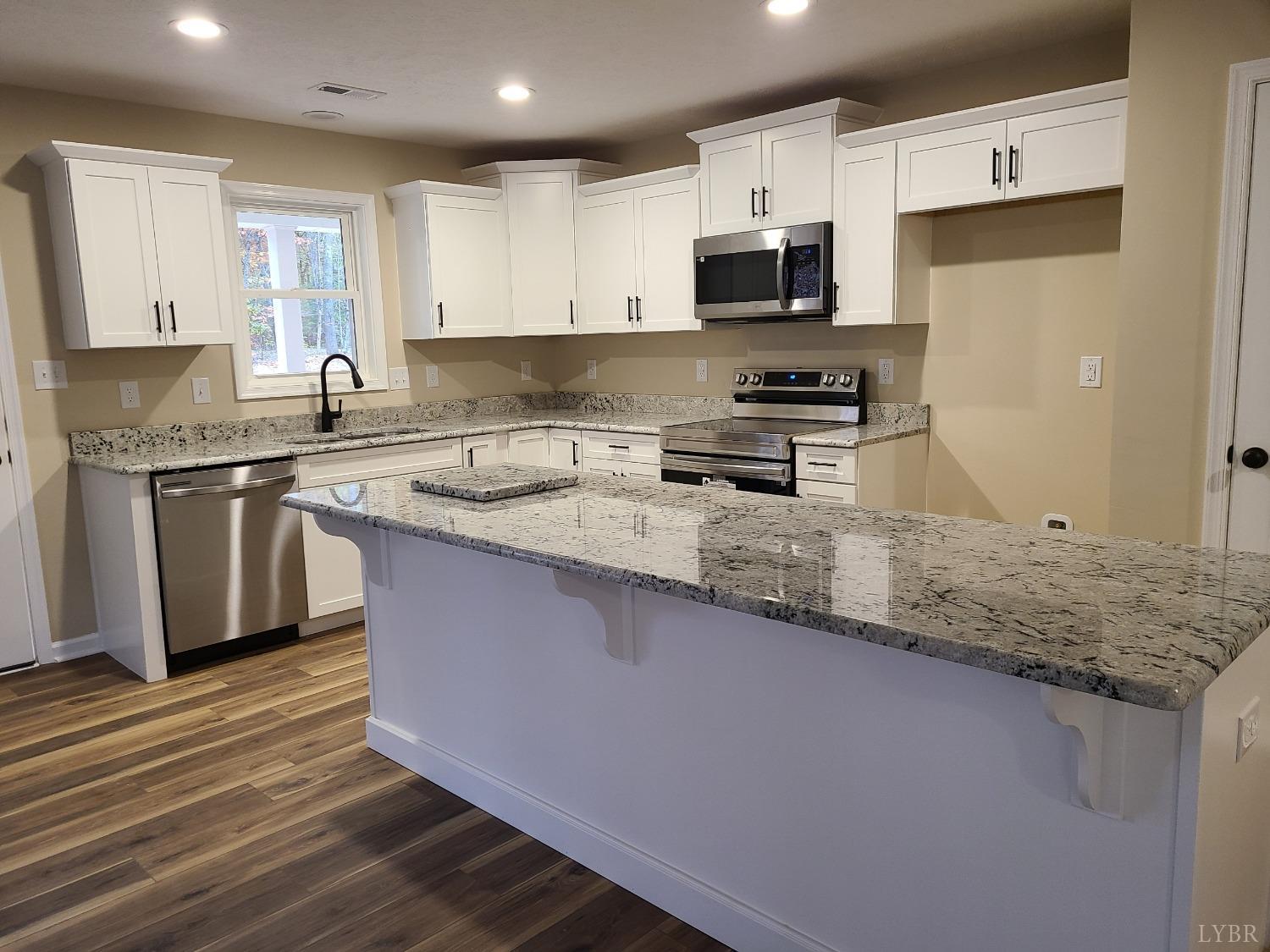 2375 Stonewall Road Concord, VA 24538 - Photo 4 of 13 a kitchen with stainless steel appliances granite countertop a sink stove microwave and refrigerator
