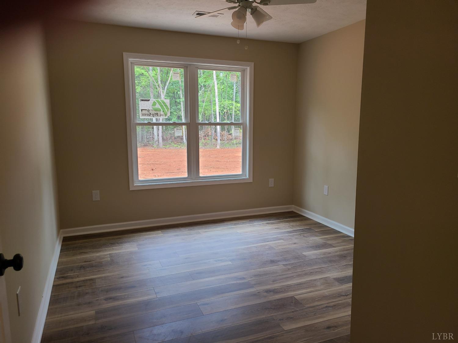 2375 Stonewall Road Concord, VA 24538 - Photo 7 of 13 an empty room with wooden floor and windows