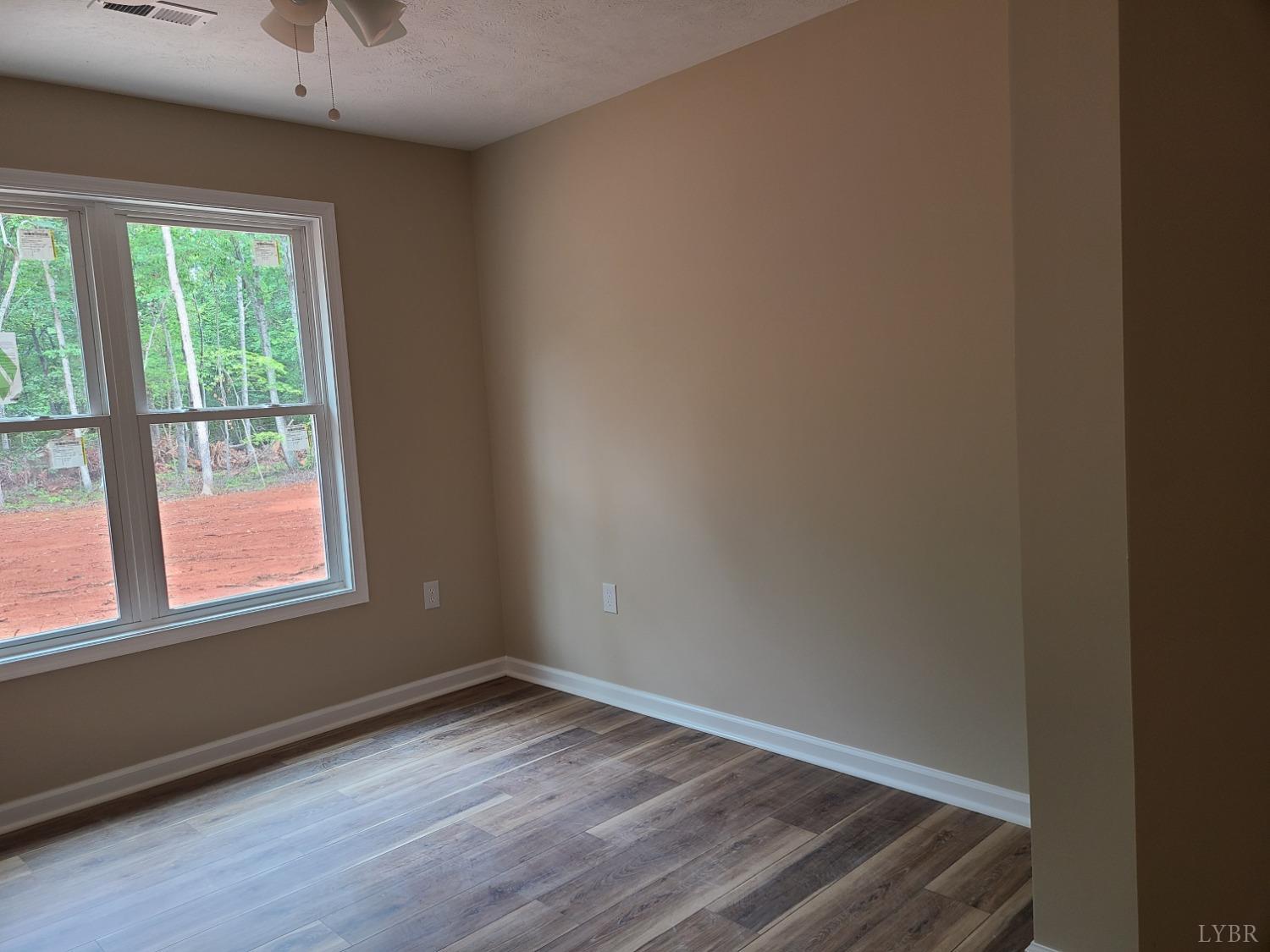 2375 Stonewall Road Concord, VA 24538 - Photo 8 of 13 an empty room with wooden floor and windows