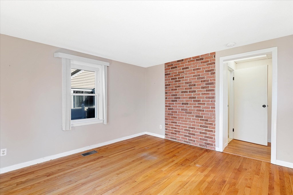 278 Plumtree Road Springfield, MA 01118 - Photo 11 of 26 a view of an empty room with wooden floor and a window