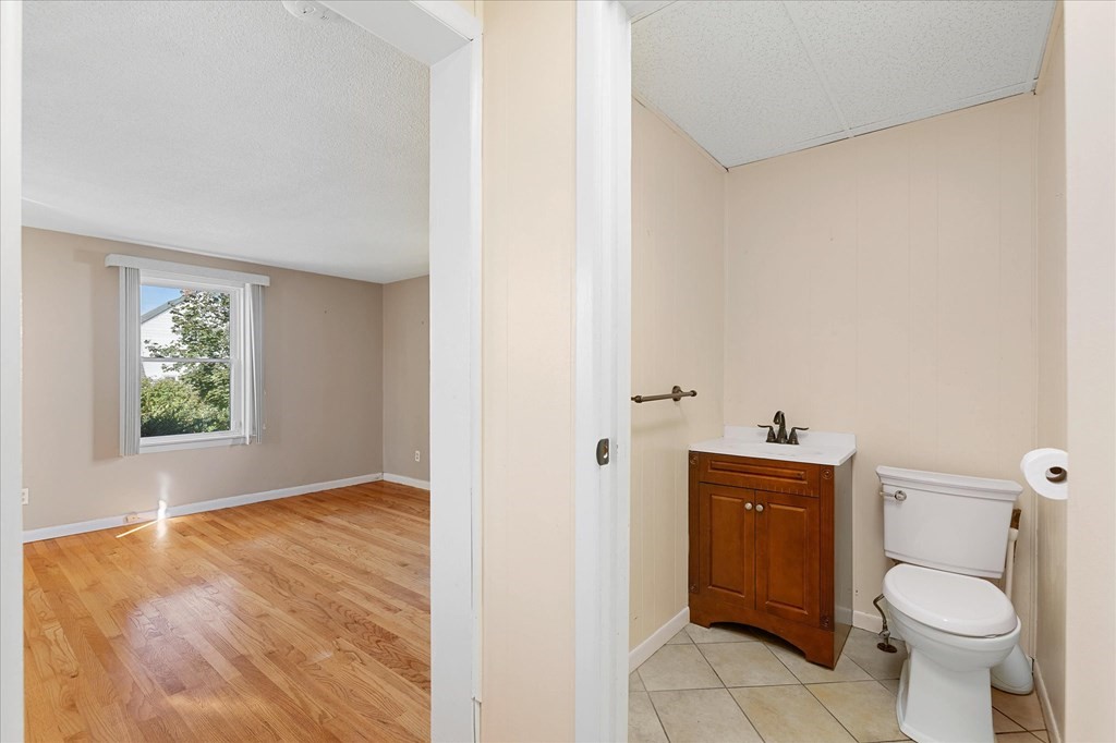 278 Plumtree Road Springfield, MA 01118 - Photo 12 of 26 a bathroom with a granite countertop toilet and a sink