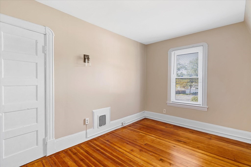 278 Plumtree Road Springfield, MA 01118 - Photo 15 of 26 a view of an empty room with wooden floor and a window