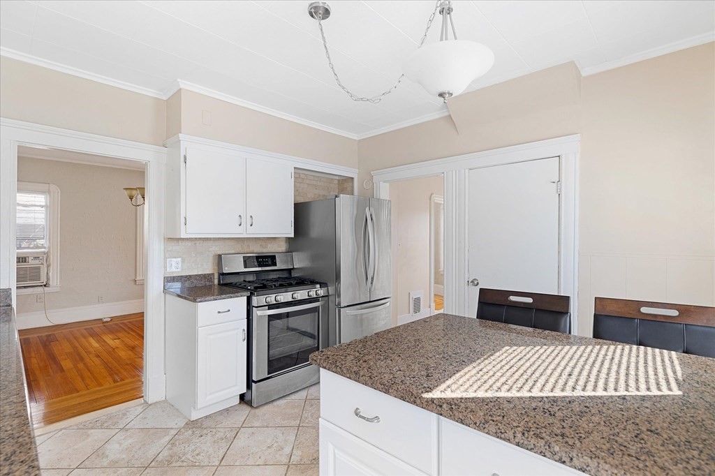 278 Plumtree Road Springfield, MA 01118 - Photo 6 of 26 a kitchen with stainless steel appliances granite countertop a sink stove and refrigerator