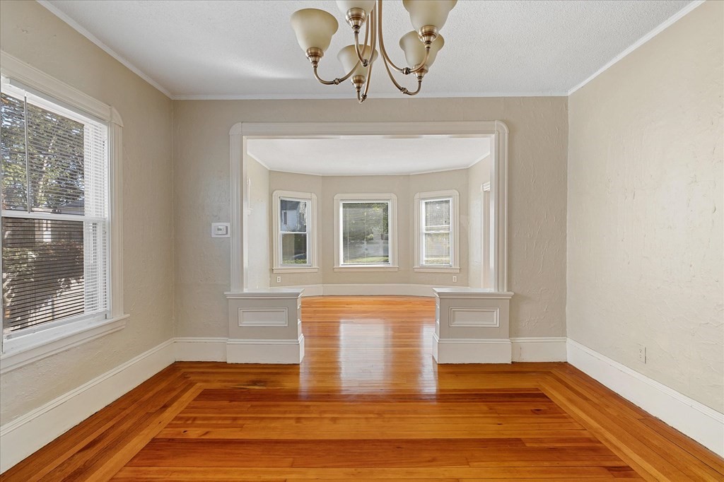 278 Plumtree Road Springfield, MA 01118 - Photo 8 of 26 a view of empty room with window and wooden floor