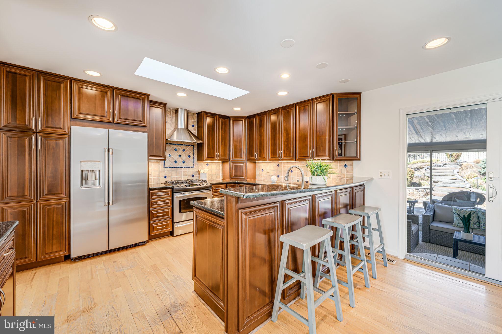 1831 Quartet Circle Vienna, VA 22182 - Photo 12 of 60 a kitchen with stainless steel appliances granite countertop a refrigerator and a stove top oven