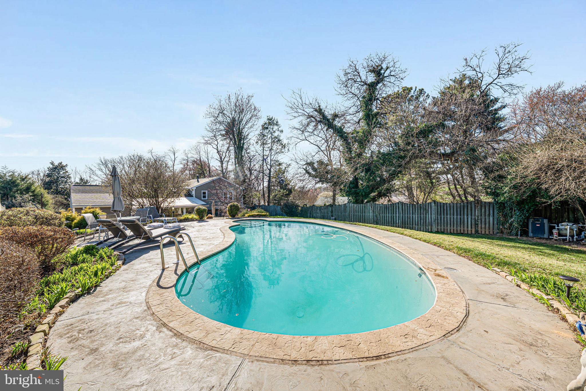 1831 Quartet Circle Vienna, VA 22182 - Photo 40 of 60 a view of a swimming pool with a yard and trees