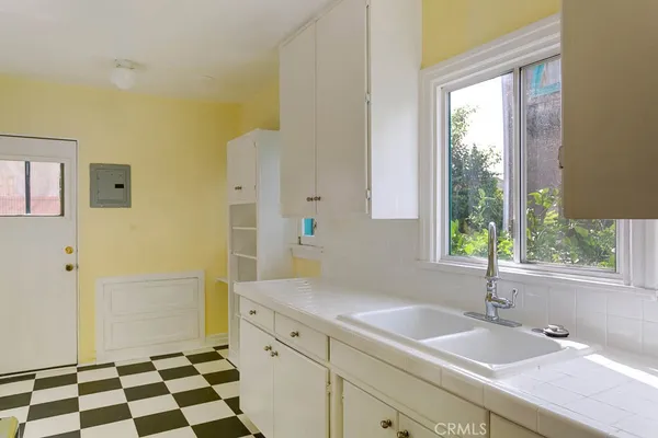 a spacious bathroom with a shower sink and mirror