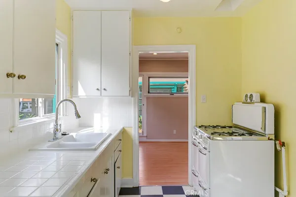 a kitchen with a sink and a stove top oven