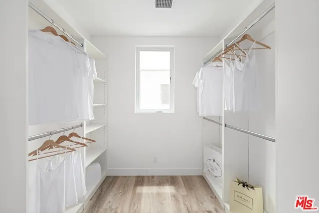 a bathroom with a window and a shower
