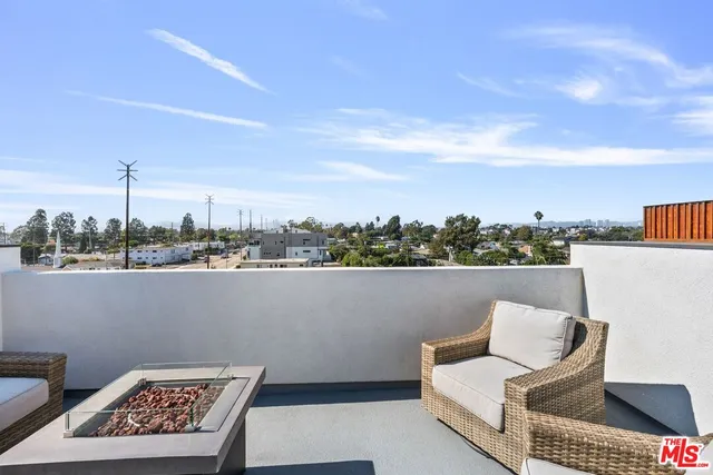 a view of roof deck with furniture