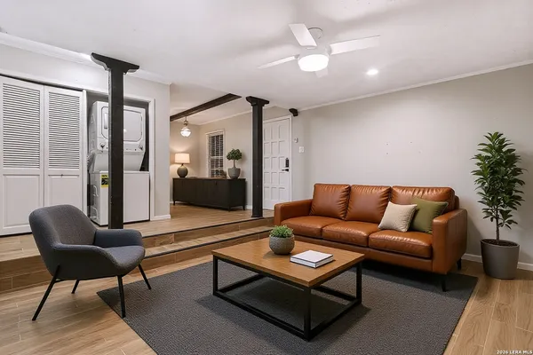 a living room with furniture and a potted plant