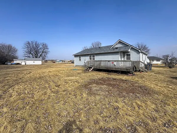 a view of a house with a yard and sitting area