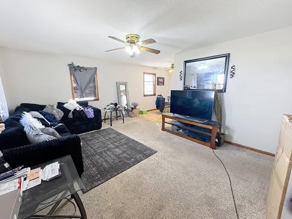 a living room with furniture gym equipment and a flat screen tv