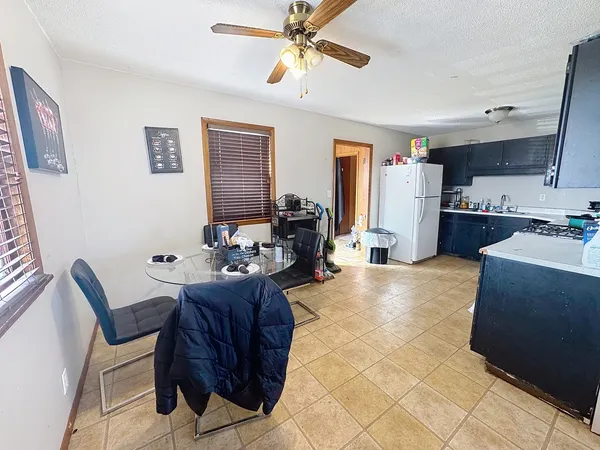 a living room with furniture a chandelier and a dining table