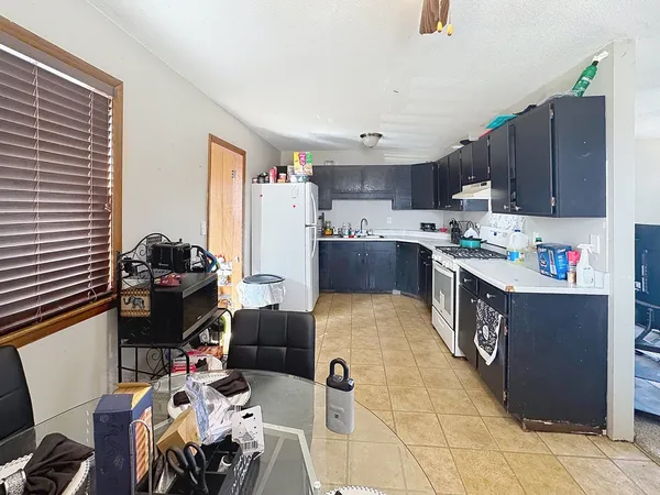 a kitchen with kitchen island a cabinets counter top space a sink and a window