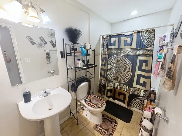 a bathroom with a toilet a sink and a mirror