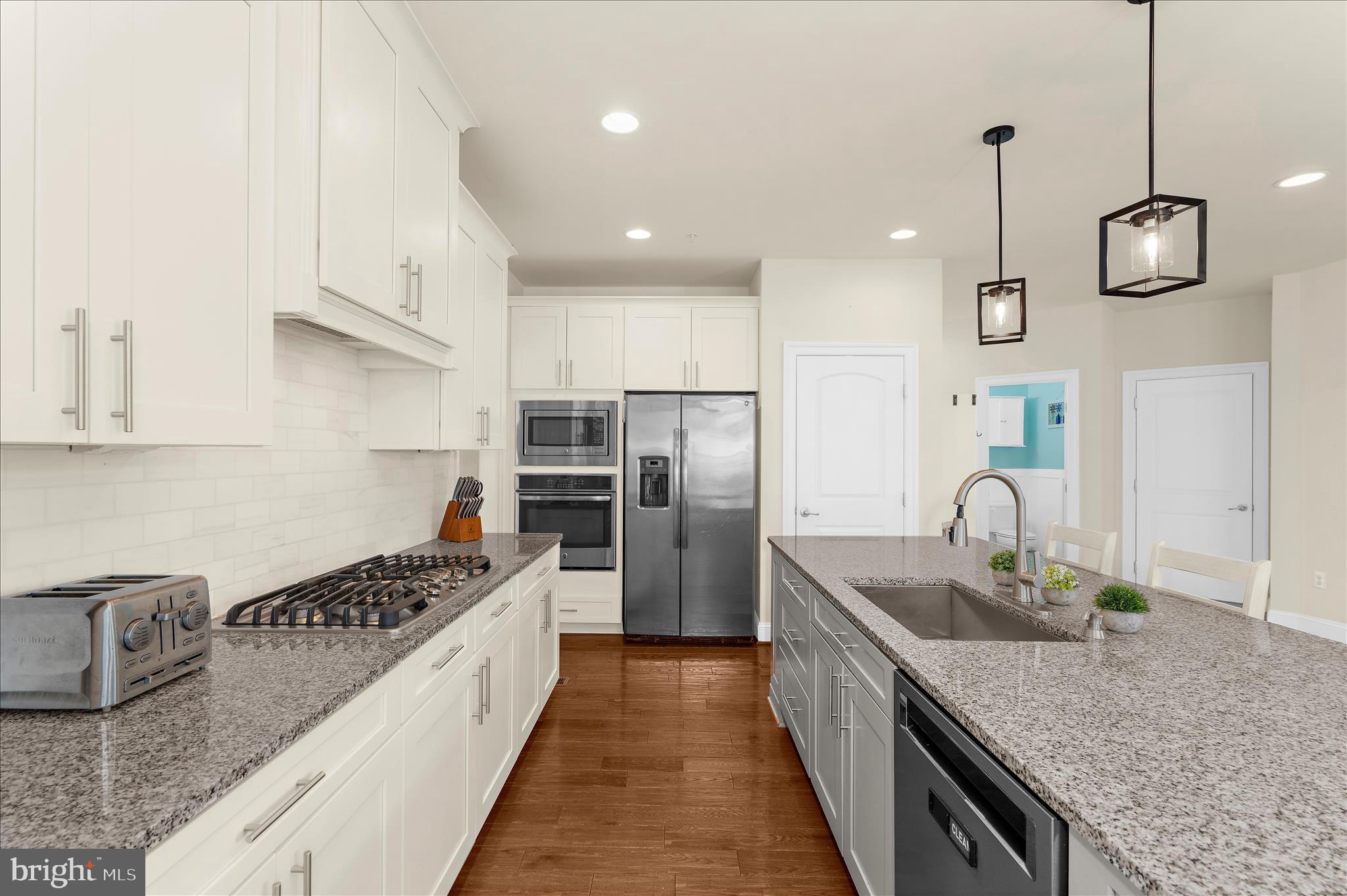 830 Sebastian Lane Gambrills, MD 21054 - Photo 14 of 63 a kitchen with kitchen island granite countertop a sink a counter space appliances and cabinets