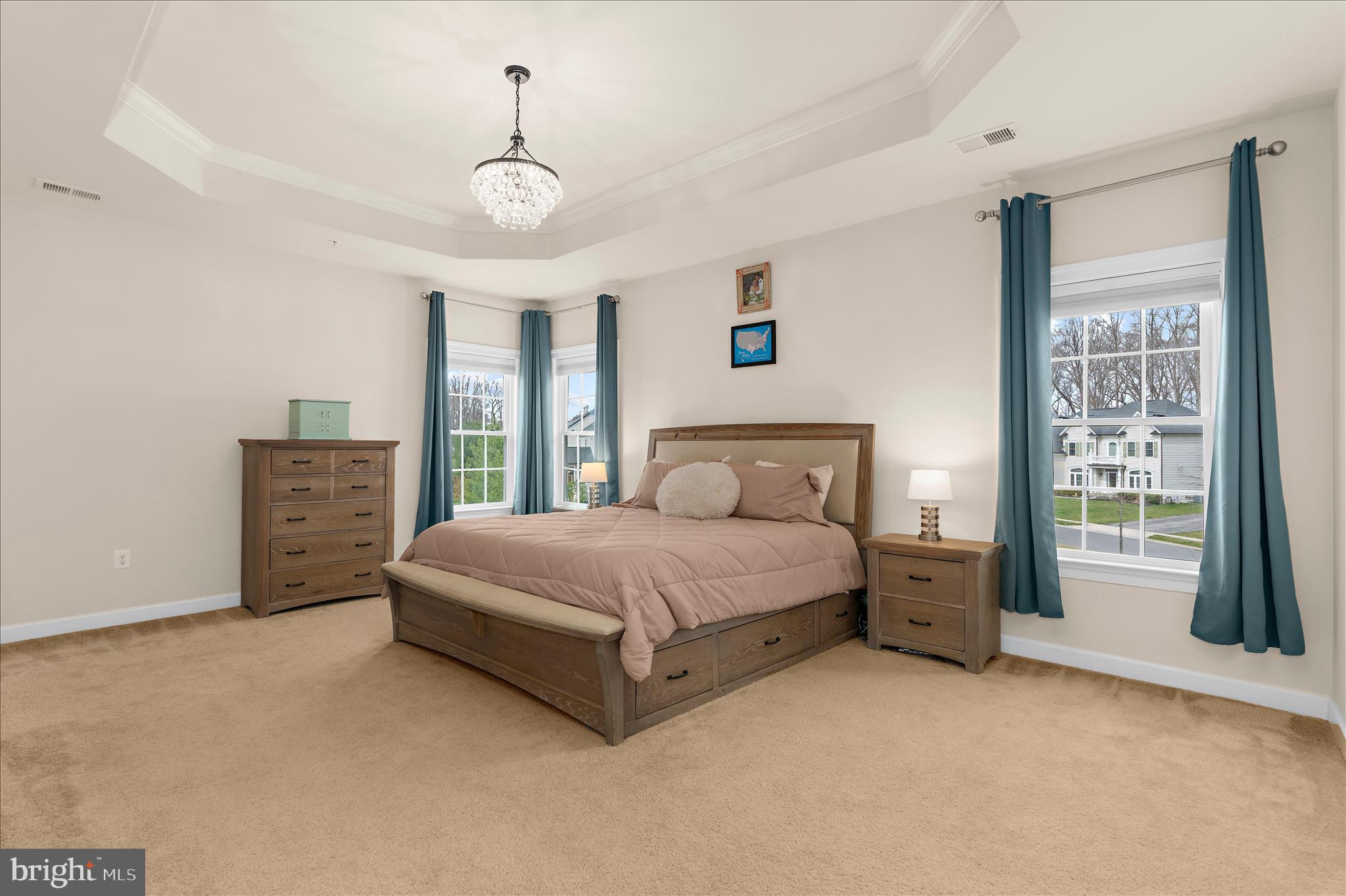 830 Sebastian Lane Gambrills, MD 21054 - Photo 26 of 63 a spacious bedroom with a large bed and a chandelier