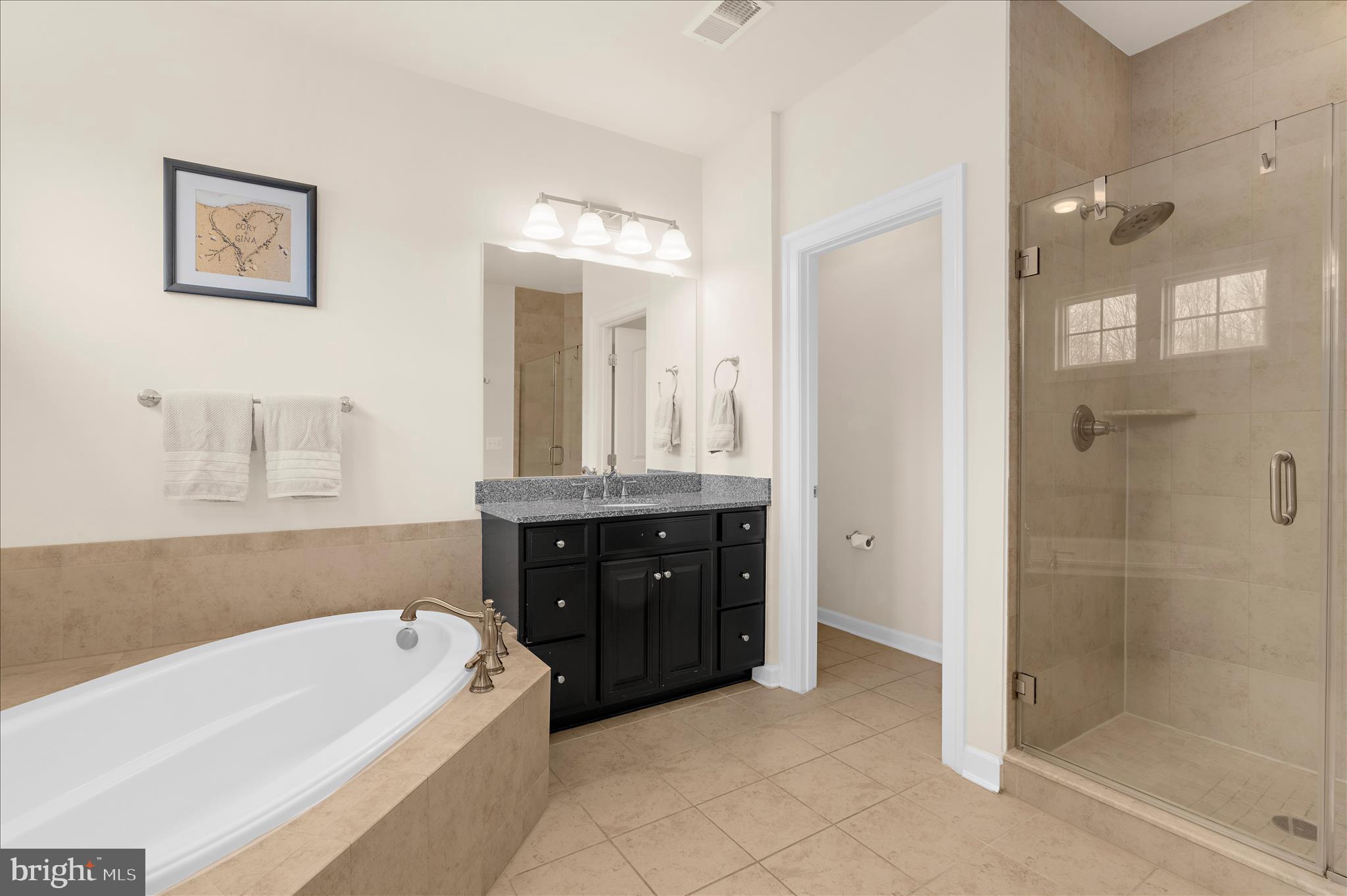 830 Sebastian Lane Gambrills, MD 21054 - Photo 27 of 63 a bathroom with a tub a double vanity sink and shower