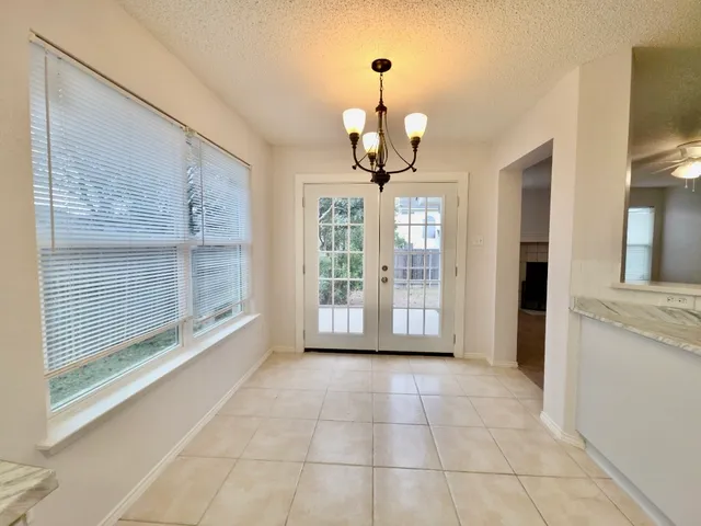 a view of an empty room with a kitchen