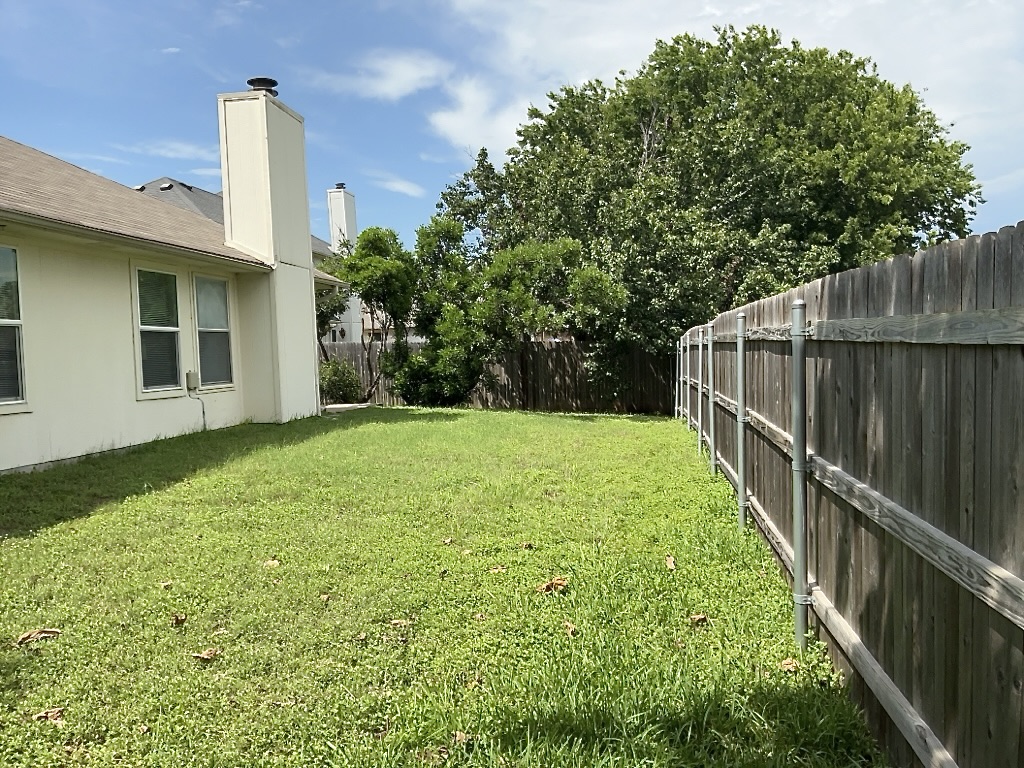 1313 Terra Street Round Rock, TX 78665 - Photo 25 of 25 a view of a backyard with a garden