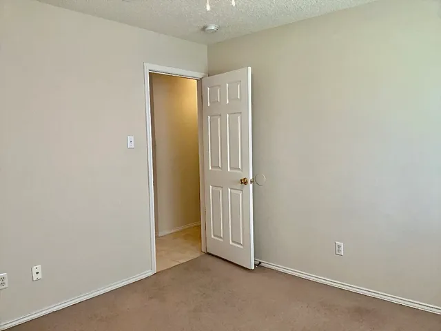 an empty room with closet area