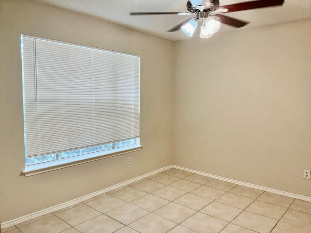 1313 Terra Street Round Rock, TX 78665 - Photo 3 of 25 a view of a small space with wooden floor and a chandelier fan