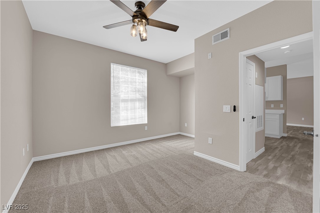 231 West Horizon Ridge Parkway, Unit 1313 Henderson, NV 89012 - Photo 11 of 20 Empty room with light carpet and ceiling fan