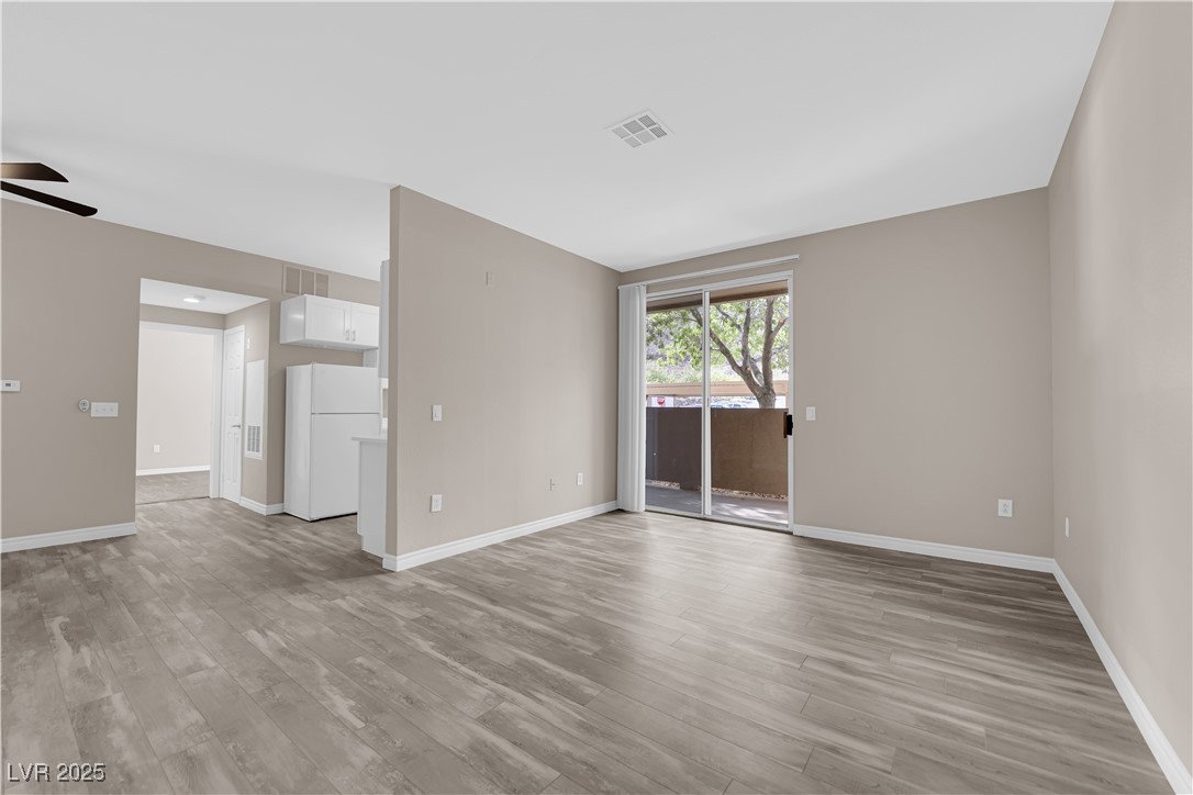 231 West Horizon Ridge Parkway, Unit 1313 Henderson, NV 89012 - Photo 2 of 20 Unfurnished room with light wood finished floors and a ceiling fan