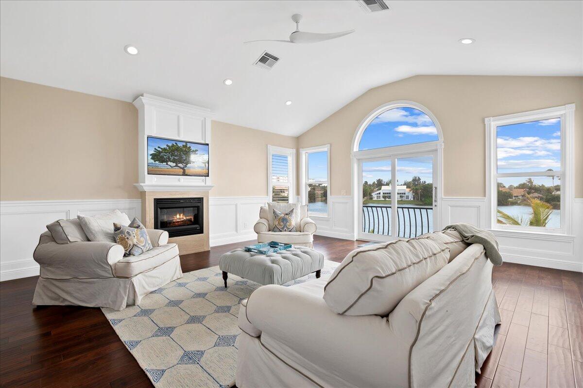 169 Apollo Circle Jupiter, FL 33477 - Photo 16 of 39 a living room with furniture fireplace and a large window