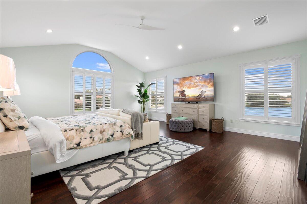 169 Apollo Circle Jupiter, FL 33477 - Photo 18 of 39 a bedroom with a bed and wooden floor