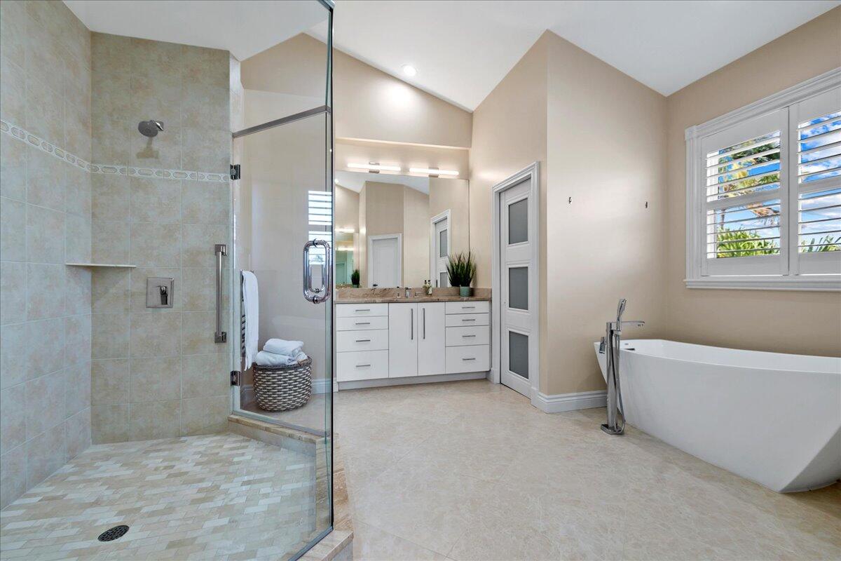169 Apollo Circle Jupiter, FL 33477 - Photo 19 of 39 a bathroom with a tub a toilet a sink and shower