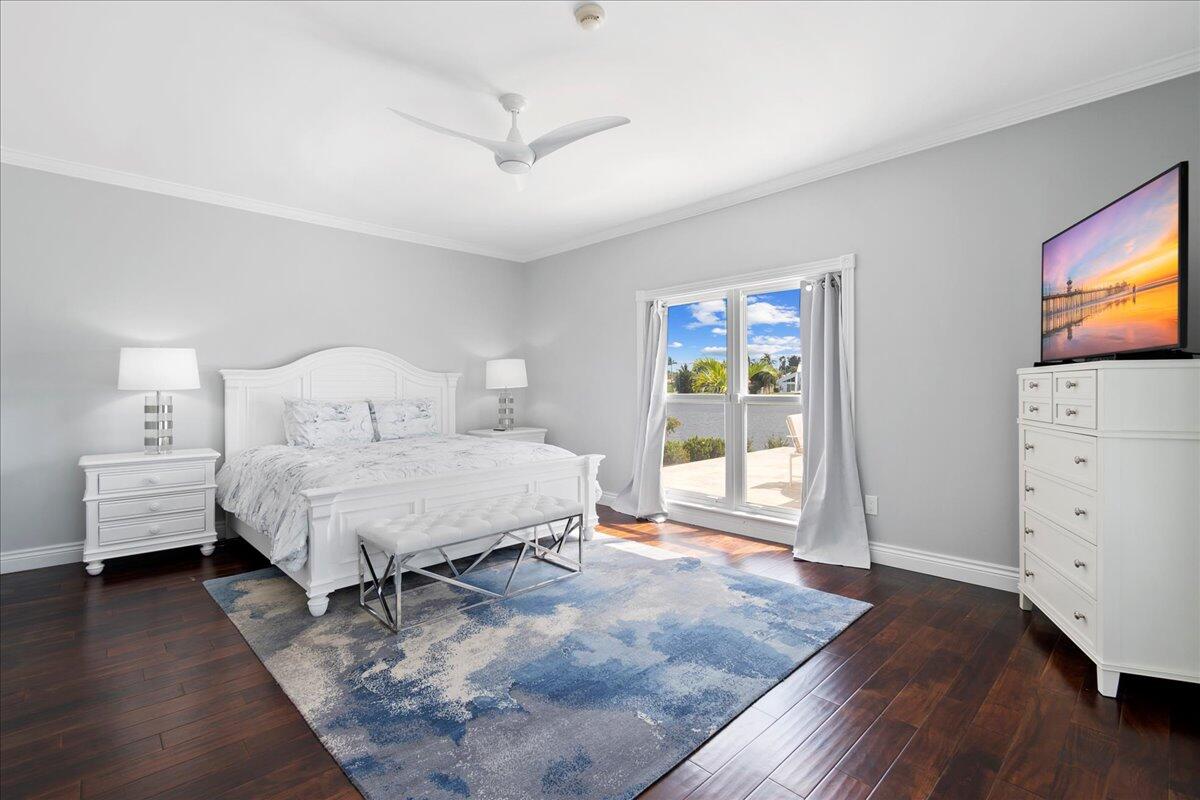 169 Apollo Circle Jupiter, FL 33477 - Photo 20 of 39 a bedroom with a bed and wooden floor