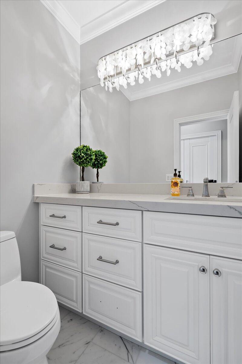 169 Apollo Circle Jupiter, FL 33477 - Photo 21 of 39 a bathroom with a sink a mirror and a potted plant
