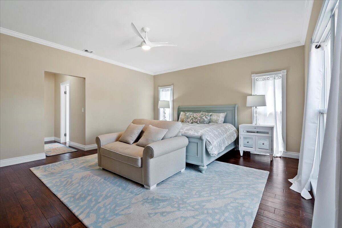 169 Apollo Circle Jupiter, FL 33477 - Photo 24 of 39 a bedroom with a bed and a wooden floor
