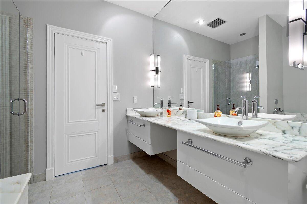 169 Apollo Circle Jupiter, FL 33477 - Photo 25 of 39 a bathroom with a double vanity sink and mirror