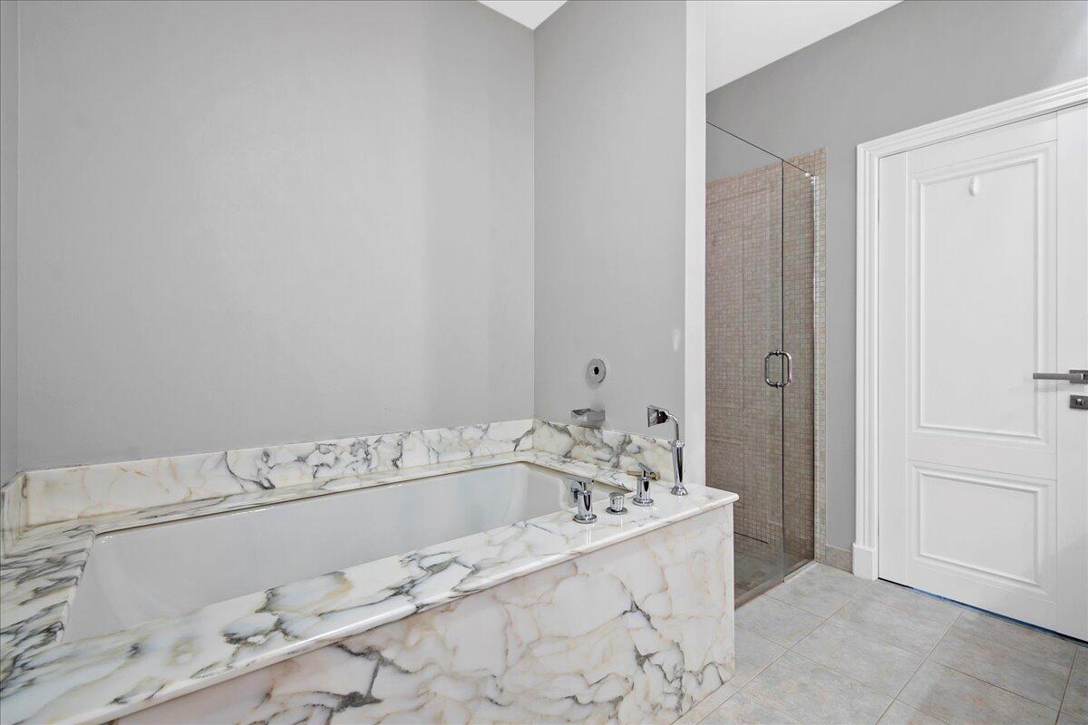 169 Apollo Circle Jupiter, FL 33477 - Photo 26 of 39 a bathroom with a bathtub and shower