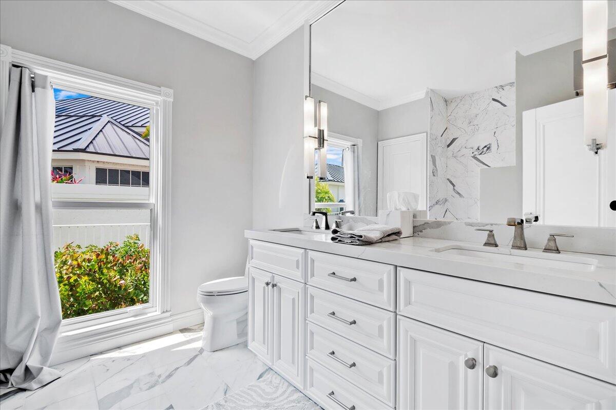 169 Apollo Circle Jupiter, FL 33477 - Photo 27 of 39 a bathroom with a granite countertop sink mirror vanity and toilet