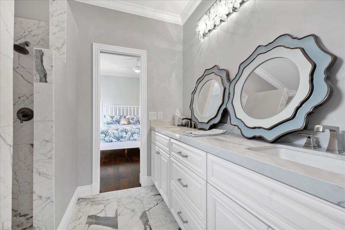 169 Apollo Circle Jupiter, FL 33477 - Photo 28 of 39 a spacious bathroom with a granite countertop sink a mirror and shower