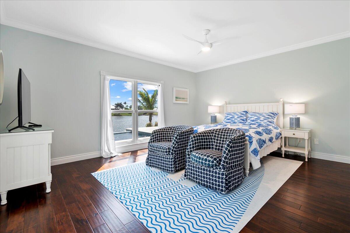 169 Apollo Circle Jupiter, FL 33477 - Photo 29 of 39 a bedroom with a bed and wooden floor