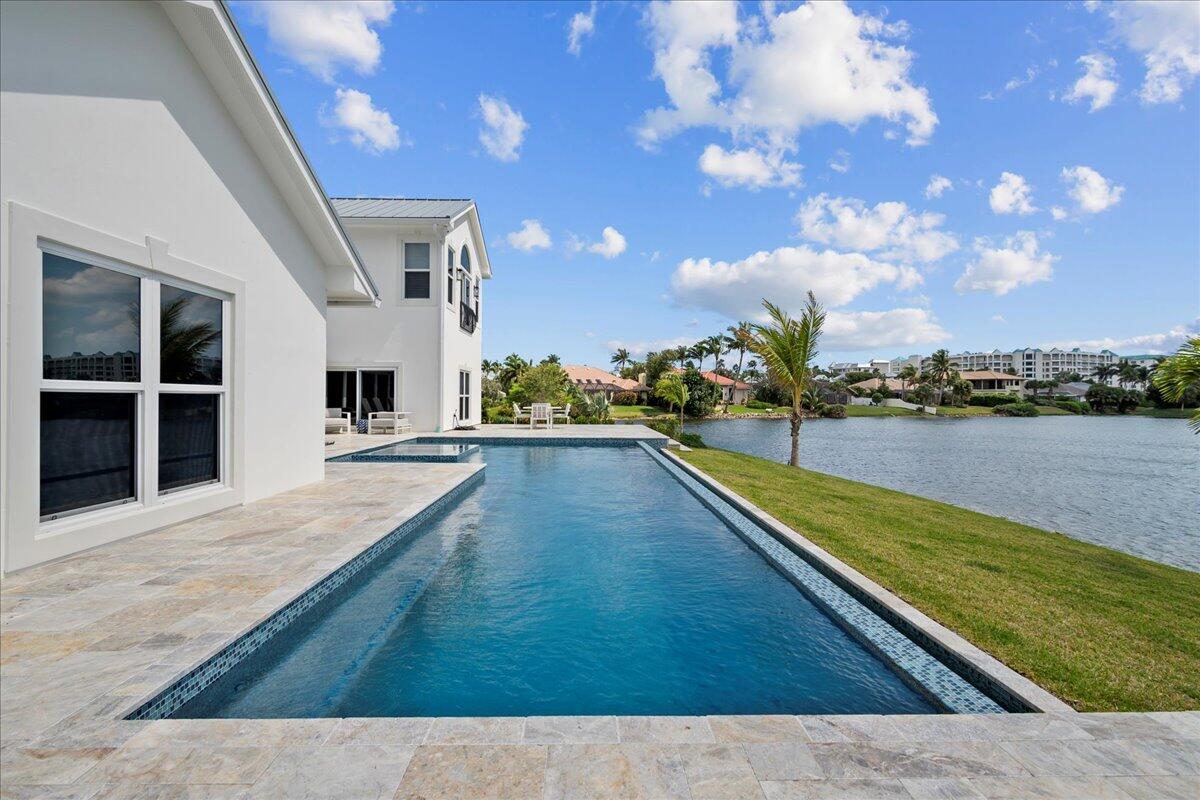 169 Apollo Circle Jupiter, FL 33477 - Photo 38 of 39 a view of swimming pool with outdoor seating and plants