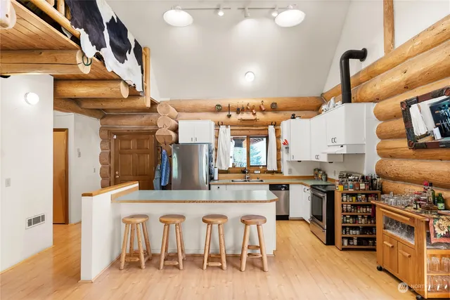 a kitchen with sink refrigerator and stove